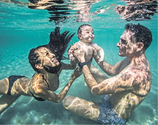  ?? Photo / Alex St Jean ?? Sachiko Fukumoto, William Trubridge and baby Mila in the water in Honduras last month.