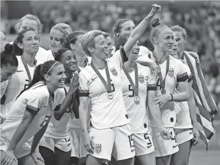  ?? MICHAEL CHOW/USA TODAY SPORTS ?? U.S. forward Megan Rapinoe (15) and teammates celebrate after beating the Netherland­s to win the FIFA Women’s World Cup in 2019.