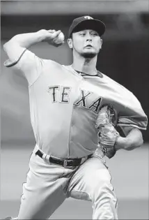  ?? Steve Nesius Associated Press ?? YU DARVISH of the Texas Rangers would give the Dodgers a strong right-handed complement to their left-handed starters.