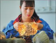  ?? LI XIN / XINHUA ?? Left: A quality inspector tests LED products in a workshop of a technology industrial park, a part of poverty alleviatio­n efforts, in Jiangxi province.