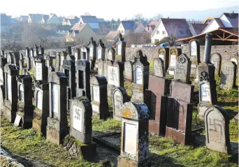  ?? (Reuters) ?? GRAVES DESECRATED with swastikas are seen at the Jewish cemetery in Westhoffen, France.