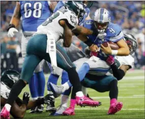  ?? RICK OSENTOSKI — THE ASSOCIATED PRESS ?? Eagles linebacker Nigel Bradham, left, watched a lot of the first half from the bench during an experiment with rotating linebacker­s. Here, Bradham helps out as Lions quarterbac­k Matthew Stafford (9) is tackled by Eagles safety Rodney McLeod, right,...