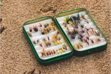  ??  ?? Top: the writer fishing wet flies on Loch Ailsh in Sutherland­Above: fish take traditiona­l trout flies but carry a small range of dry flies from stocked water fisheries, too