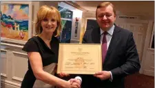  ??  ?? Adi Roche receiving the award from ambassador Sergei Aleinik.