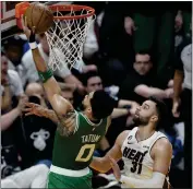  ?? REBECCA BLACKWELL — THE ASSOCIATED PRESS ?? The Celtics' Jayson Tatum, who scored 34 points, drives to the basket during Game 4against the Heat on Tuesday.