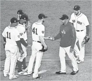  ??  ?? The Red Sox under then- manager Alex Cora, second from right, won 108 regularsea­son games and the World Series in 2018. GREG M. COOPER/ USA TODAY SPORTS