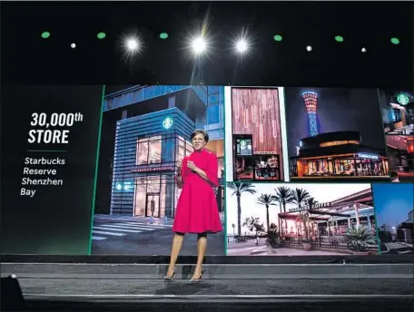  ?? Jason Redmond AFP/Getty Images ?? STARBUCKS opened its 30,000th store in March and now has 30,626. The company’s chief operations officer, Rosalind Brewer, helped celebrate the milestone. Starbucks had $24.7 billion in revenue in fiscal 2018 and “is very much a growth company” again, one analyst said.