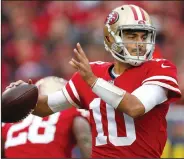  ?? NHAT V. MEYER/TRIBUNE NEWS SERVICE ?? 49ers starting quarterbac­k Jimmy Garoppolo, seen here throwing against the Jaguars in December, signed a longterm deal this offseason.