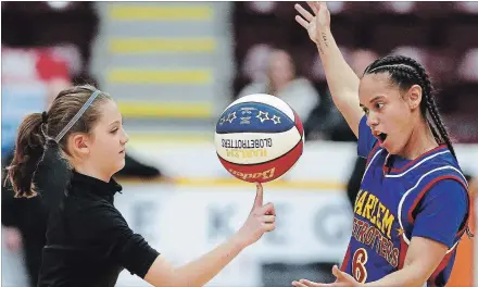  ??  ?? Emma Fisher, 11, shows off her talents with Hoops as the Harlem Globetrott­ers entertain the Washington Generals in the 2018 Amazing Feats of Basketball World Tour on Thursday at the Memorial Centre.