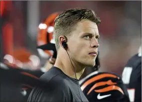  ?? JASON BEHNKEN — THE ASSOCIATED PRESS ?? Cincinnati Bengals quarterbac­k Joe Burrow (9) watches from the sidelines during the first half of an NFL preseason football game against the Tampa Bay Buccaneers Saturday,
Aug. 14, 2021, in Tampa, Fla.