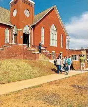  ??  ?? Visitors walk along a sidewalk in front of Eighth Street Church during an open house on March 31 at the newly renovated church building in Midtown.