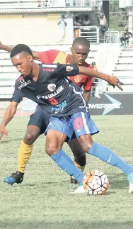  ?? FILE ?? St Andrew Technical’s Steven McQueen challenges Jamaica College’s Tyreek Magee during a ISSA/FLOW Manning Cup encounter in Montego Bay earlier this season.