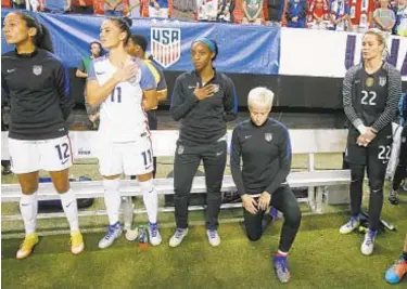  ?? GETTY ?? Megan Rapinoe kneels as national anthem is played before exhibition match in 2016.