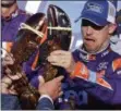  ?? CHARLES KRUPA — THE ASSOCIATED PRESS ?? Driver Denny Hamlin reacts as he is handed a lobster after winning Sunday’s race at New Hampshire Motor Speedway in Loudon, N.H.