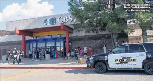  ??  ?? Police vehicle outside the Music City Mall in Odessa
after the mass shooting