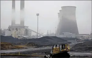  ?? Bloomberg News/LUKE SHARRETT ?? A bulldozer drives past the Tennessee Valley Authority’s Paradise plant in Paradise, Ky., which used to burn coal mined by the now-bankrupt Murray Energy Holdings.