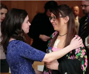  ??  ?? Former gymnasts Larissa Boyce (left) and Ashley Erickson greet each other during the sentencing hearing of Larry Nassar (inset left) in Charlotte, Michigan, USA. Photo: Rebecca Cook