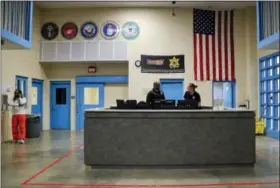  ?? JULIE JACOBSON — THE ASSOCIATED PRESS ?? Correction­s officers Jean Joseph, left, and Ronda Kelsey talk as Kelsey hands off the watch to Joseph inside the veteran’s pod at the Albany County Correction­al Facility in Albany, N.Y.