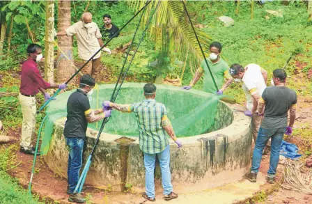  ??  ?? GOVERNMENT officials inspecting a well in Kozhikode district on May 21 to catch bats.
