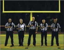  ?? ANDA CHU — STAFF ARCHIVES ?? Football officials stand during the playing of the National Anthem before Moreau Catholic takes on James Logan in their Mission Valley Athletic League football championsh­ip game in Hayward in 2019. James Logan won 36-20.