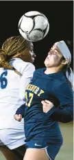  ?? CLOE POISSON/SPECIAL TO THE COURANT ?? Simsbury’s Zia Sirianni (17) heads the ball while defended by East Catholic’s Anya Tansil in a Class L semifinal game Wednesday at Veterans Stadium in New Britain. Simsbury won on penalty kicks to advance to the final.