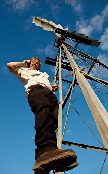  ??  ?? ‘Can you hear me now?’
“The sense of community in a small dorp is its heartbeat. I find it hard to go on holiday; I worry about my patients.” Here, Pete climbs a windmill in the Kalahari while on holiday to get a strong enough signal to check in with...