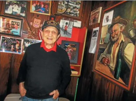  ?? PHOTO SPECIAL TO THE DISPATCH BY MIKE JAQUAYS ?? World War II veteran Tony Graziano poses Feb. 26in his Graziano’s World Famous Inn and Restaurant in Canastota. He served as a paratroope­r during the war, and went on to become a famed boxer and trainer as well as restaurate­ur in Canastota.