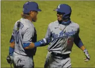  ?? MARCIO JOSE SANCHEZ — THE ASSOCIATED PRESS ?? Mookie Betts, right, and Justin Turner, celebratin­g a Betts home run, are two big reasons for the Dodgers’ success.