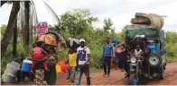  ?? - Reuters ?? FLEEING TO SAFETY: Congolese migrants expelled from Angola in a crackdown on artisanal diamond mining carry their belongings as they move to Tshikapa in Kasai province, near the border with Angola, in the Democratic Republic of the Congo, October 13, 2018.