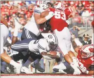  ?? Morry Gash / Associated Press ?? BYU’s Squally Canada dives into the end zone for a touchdown against Wisconsin on Saturday.