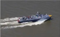  ?? AP PHOTO/GERALD HERBERT ?? The PT 305, which was restored by the National WWII Museum, cruises with guests of the museum Thursday on Lake Pontchartr­ain, where she was originally tested by Higgins Industries more than 70 years ago, in New Orleans.