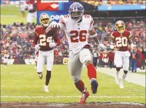  ?? Patrick Smith / Getty Images ?? Giants running back Saquon Barkley celebrates at the end of his 78-yard touchdown run in the second quarter against the Redskins.