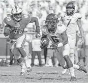  ?? Paul Moseley / Fort Worth Star-Telegram/TNS ?? TCU’s Darius Anderson, right, scores on a 4-yard run in the third quarter against SMU at Amon Carter Stadium in Fort Worth.