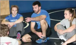  ?? / Jonathan Blaylock ?? Armuchee head coach Joey Harris (center) talks with his team before the start of a practice session Monday. The coach is flanked by Jamison Powell (left) and Kelsie Burkett.