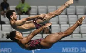  ?? CHRISTOPHE SIMON/AFP/GETTY IMAGES ?? Canada’s Jennifer Abel and Francois Imbeau-Dulac capped a dream season in mixed three-metre synchro springboar­d diving with a bronze medal at the worlds on Saturday.