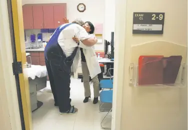  ?? Photos by Michael Macor / The Chronicle ?? Diabetes patient Paul Haskins of San Bruno gets treatment, top, and a hug, above, from nurse practition­er Yuwen Liao at San Mateo Medical Center. Haskins says he fears he could lose his health coverage.