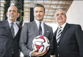  ?? GETTY IMAGES ?? MLS Commission­er Don Garber, David Beckham and Miami-Dade Mayor Carlos Gimenez (left to right) are close to finalizing a Miami expansion franchise.