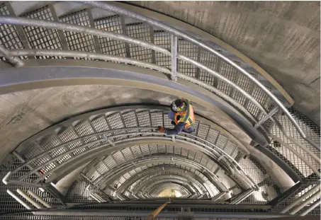  ?? Photos by Paul Chinn / The Chronicle ?? Field operations manager John Rocca climbs a staircase inside the new intake tower of the Calaveras Dam replacemen­t project.