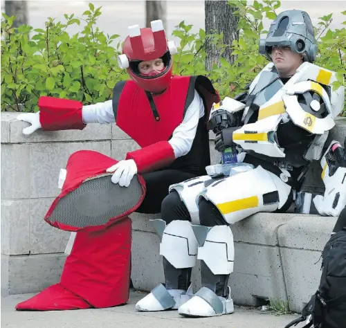  ?? ED KAISER/ EDMONTON JOURNAL ?? Brett Lewis, left, dressed as Magnet Man from Mega Man 3 and Eric Orton, a Cerberus assault trooper from Mass Effect 3, take a break Friday outside the 20th annual Animethon, a Japanese animation (“anime”) themed festival at MacEwan University. Events...