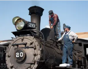  ??  ?? Colorado Railroad Museum volunteers Dusty Thompson and Mark Huber load sand into the front dome of Rio Grande Southern 4-6-0 No. 20 at Antonito, Colo., prior to its mainline debut. The 1899 Schenectad­y product’s multiyear rebuild was completed in 2020.