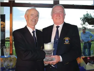  ??  ?? Past President’s award winner Leonard Murphy receives his prize from Wickow Golf Club President Moses Coffey.