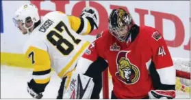  ?? SEAN KILPATRICK — THE ASSOCIATED PRESS ?? Ottawa Senators goalie Craig Anderson reacts as Penguins center Sidney Crosby celebrates his goal in the second period of Game 4 of the Eastern Conference finals on Friday.