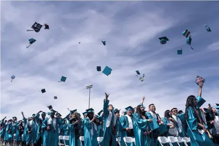  ??  ?? Capital graduates celebrate earning their diplomas Thursday at the end of the commenceme­nt ceremony on the football field. Principal Channell Wilson-Segura told the class in her commenceme­nt address that poverty, a constant companion of many students...