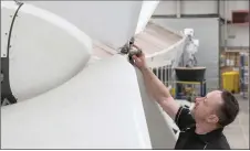  ?? ?? An engineer works on a three-blade ducted propeller of an Airlander 10 prototype, at the Hybrid Air Vehicles centre, in Bedford, England.