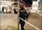  ?? AP PHOTO MARKUS SCHREIBER ?? A police officer guards the scene after a truck was driven into a department store in Stockholm, Sweden.