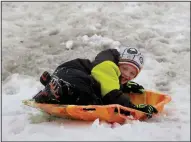  ?? AP/Telegraph Herald/JESSICA REILLY ?? Aidan Davis, 7, gets in some sledding Thursday in Dubuque, Iowa, where the high for today is forecast to be 26 degrees.