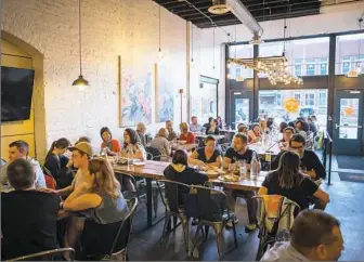  ?? Alex Driehaus/Post-Gazette ?? Restaurant patrons sit in the dining area at Smallman Galley in the Strip District.