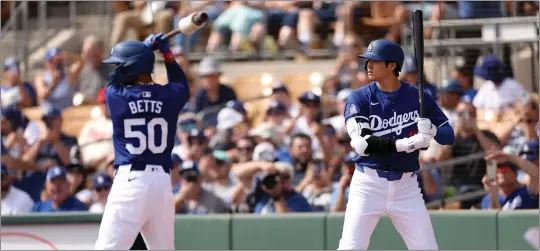  ?? CHRISTIAN PETERSEN — GETTY IMAGES ?? Mookie Betts and Shohei Ohtani are part of a potent batting order that figures to score a lot of runs for the Dodgers this season, but Betts has moved to shortstop and Ohtani will DH.