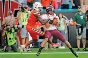  ?? AP FILE PHOTO/LYNNE SLADKY ?? Virginia Tech defensive back Caleb Farley, right, intercepti­ng a pass intended for Miami wide receiver Dee Wiggins, left, during a 2019 game.