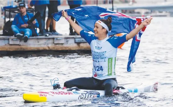  ?? Picture: ISA/BEN REED ?? Australia’s Jordan Mercer wins the women’s paddleboar­d distance race at the Internatio­nal Surfing Associatio­n World StandUp Paddle and Paddleboar­d Championsh­ips in Denmark and (below) seven years ago with uncle Dean and her father, Darren.